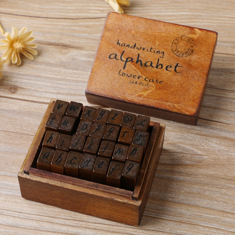 Wooden alphabet stamp set in box with cursive-style lowercase letter blocks