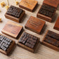 Wooden stamp sets in multiple small cases, alphabet letter blocks arranged on table