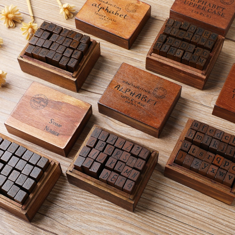 Wooden stamp sets in multiple small cases, alphabet letter blocks arranged on table
