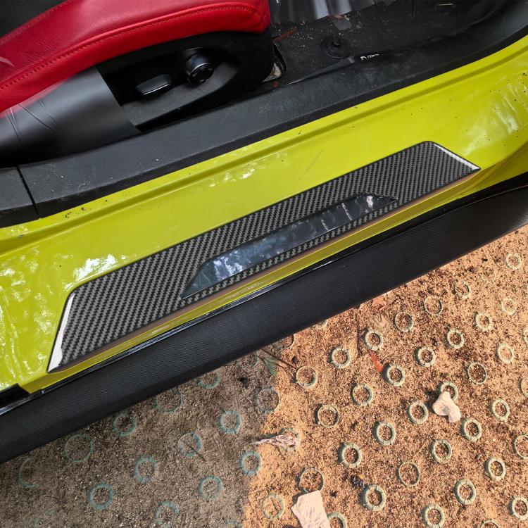 Carbon-fiber door sill trim stickers installed along the car door
