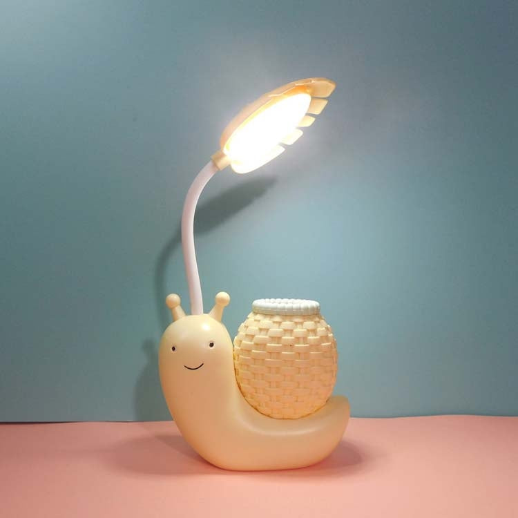 Cartoon snail LED desk lamp with woven cup shade and warm light, peach body
