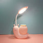 Cartoon snail LED desk lamp with woven cup shade and warm light, pink body