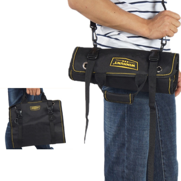 Electrician tool kit bag carried by a person with shoulder strap and front handle loops