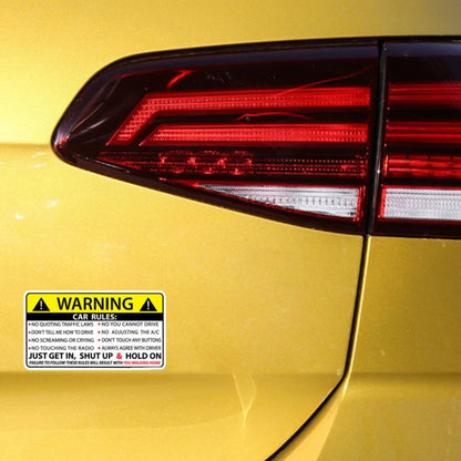 Yellow car rules warning sticker with black text and hazard icon