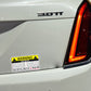 Warning car rules sticker on silver car beside rear tail light