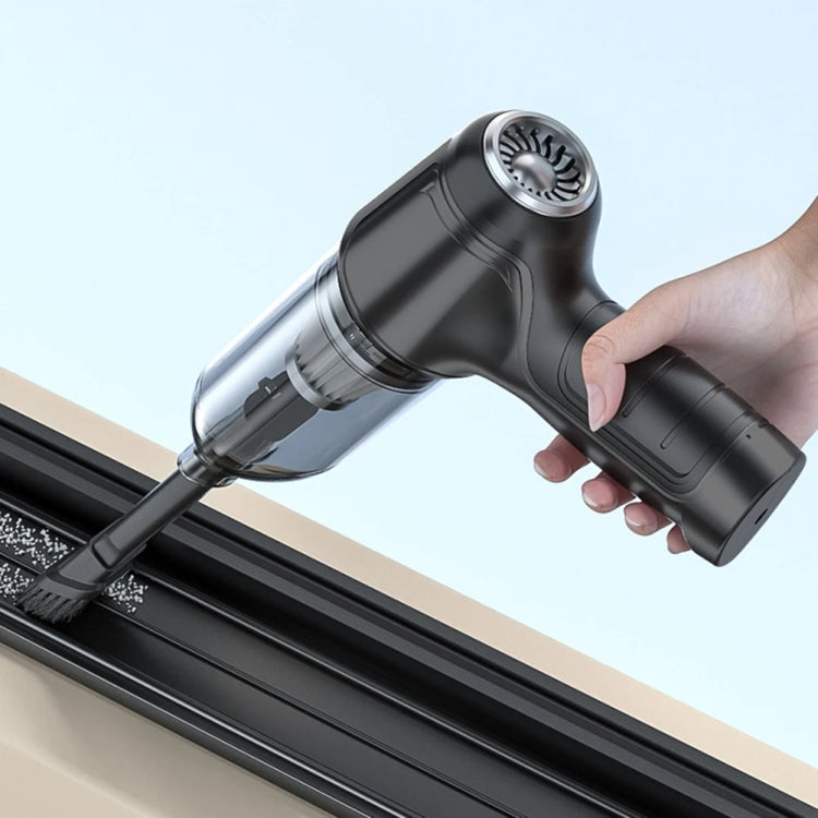 Black handheld wet/dry vacuum cleaner with round brush head and transparent dust chamber