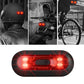 Motorbike helmet tail light, black housing with red glowing LED strips, close-up.