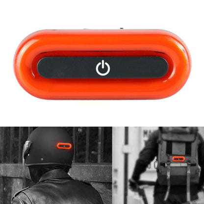 Rechargeable bike tail light with orange casing and black switch window, power icon
