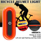 Orange bike helmet tail light with red LED glow and visible mounting strap