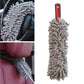Gray chenille car wash duster with red handle, shown cleaning car interior