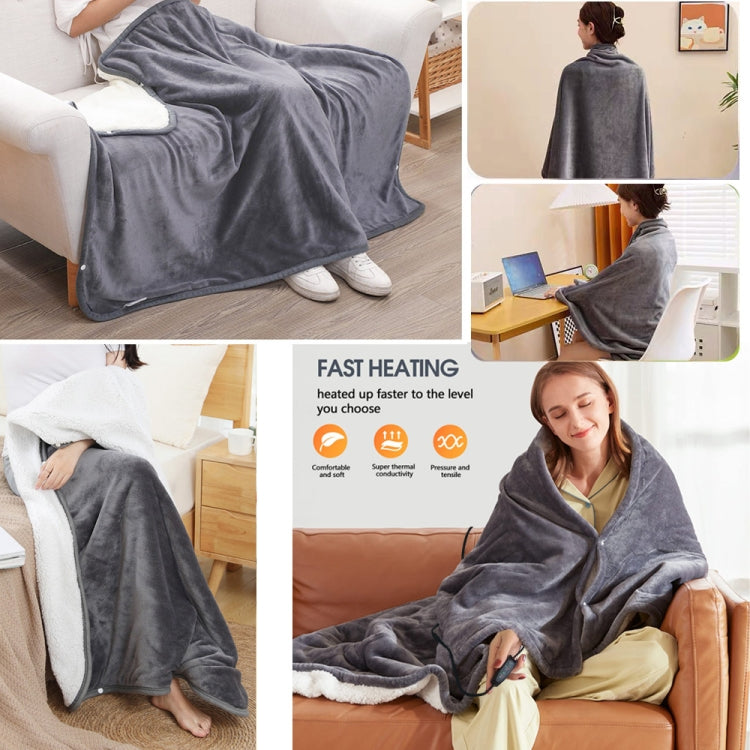 Gray electric heating shawl blanket draped over person on sofa