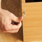 Hand tightening a hex socket screw with nut on wood panel, part of the set