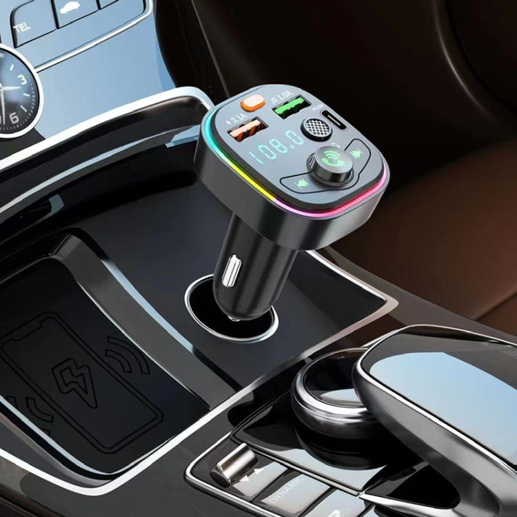 Car Bluetooth FM transmitter plugged into car dash with LED display and colored ring
