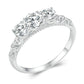 Sterling silver ring with filigree scrollwork band and five round moissanite-style stones