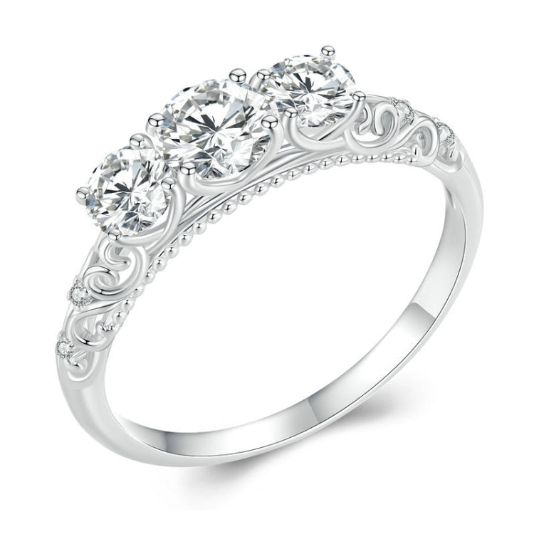 Sterling silver ring with raised filigree band and five round moissanite-style stones