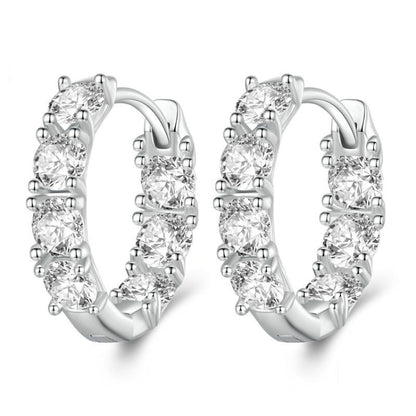 Silver hoop earrings with budding flower zirconia stones arranged along the band