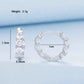 Silver hoop earrings with three-tier zirconia flower design on a hinged rim