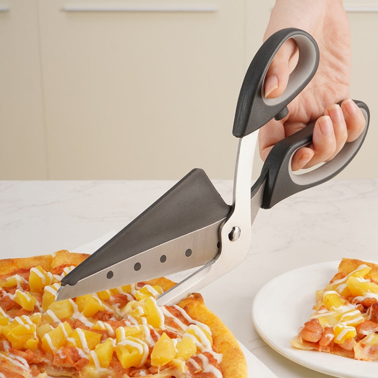 Pizza cutting scissors with stainless blades and black handles, held over sliced pizza