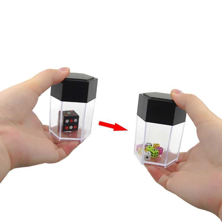 Hands holding black-lidded dice prop box with arrow showing the dice change