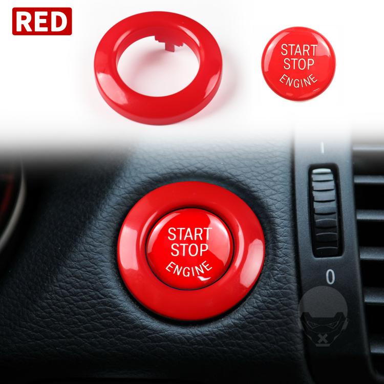 Red start/stop engine button cover and ring on car dashboard
