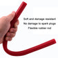 Flexible red rubber spark plug installation rod held in hand, curved