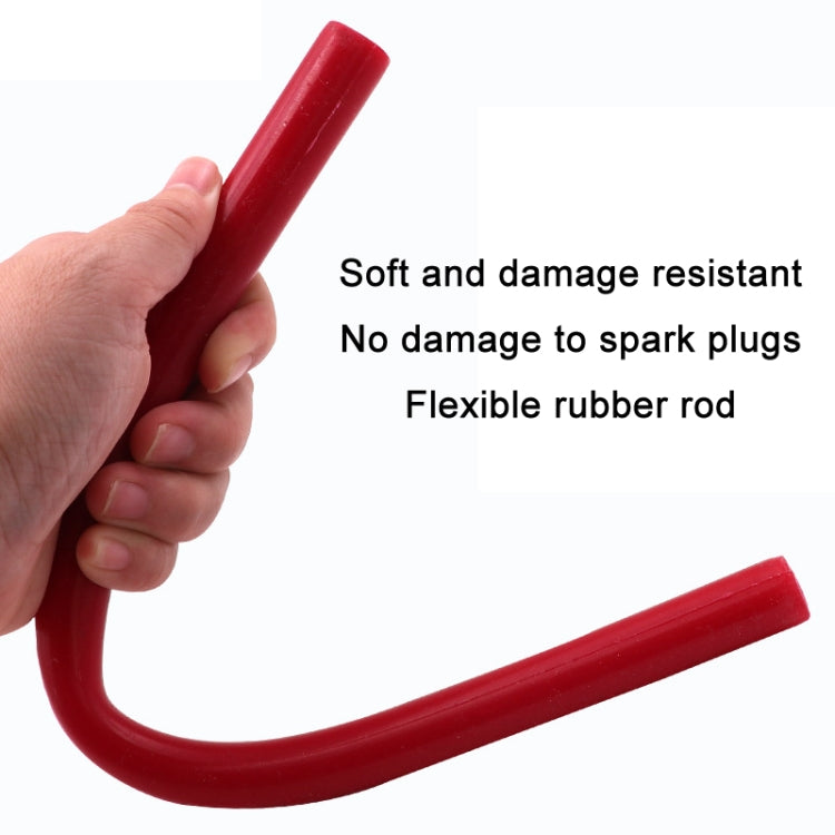 Flexible red rubber spark plug installation rod held in hand, curved