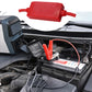 Car battery jumper cable with red and black large clamps connected to a car battery