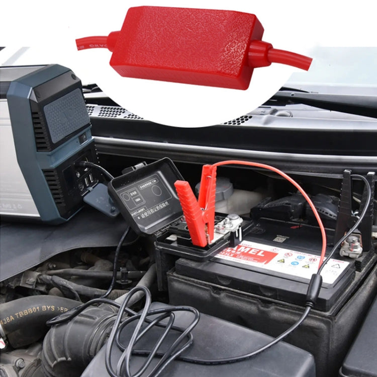 Car battery jumper cable with red and black large clamps connected to a car battery