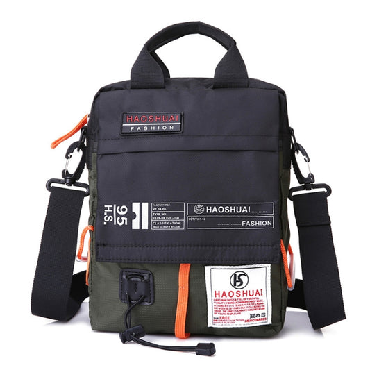 Men’s crossbody bag in dark green with orange trim, front label patch, and adjustable strap