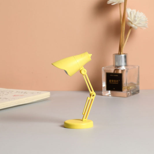 Yellow LED mini magnetic desk lamp with foldable adjustable arm and base.