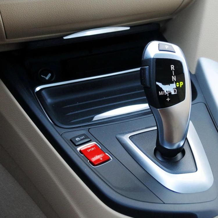 Red SPORT/ECOPRO gear mode switch button on vehicle console