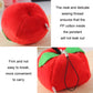 Red strawberry plush bag pendant keychain close-up with leaf and black cord.