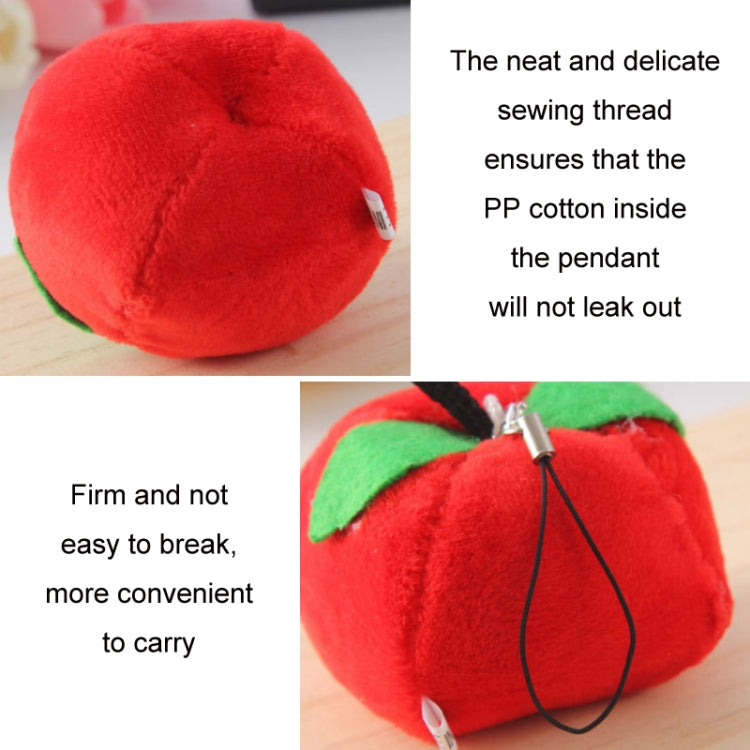 Red strawberry plush bag pendant keychain close-up with leaf and black cord.