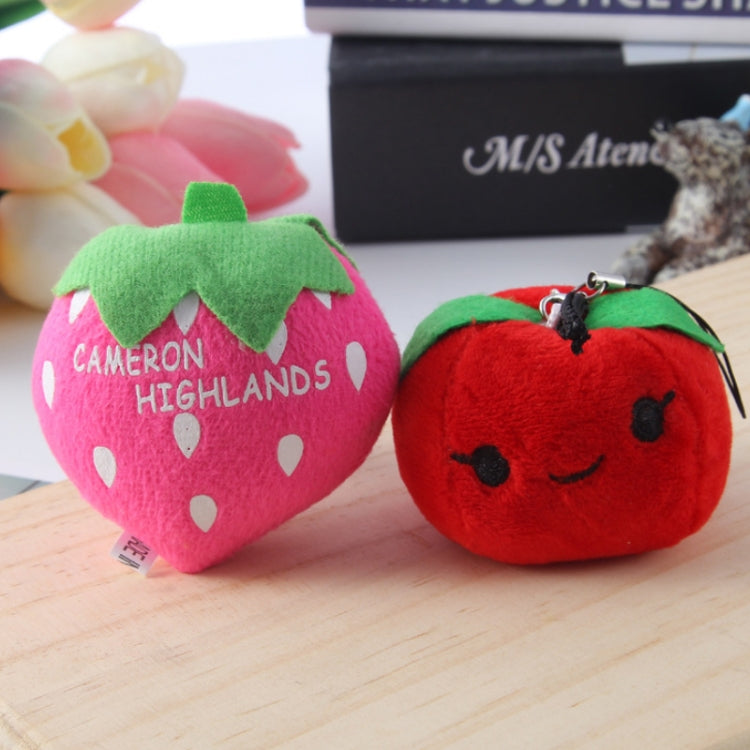 Two plush bag pendants: pink strawberry with “CAMERON HIGHLANDS” and red strawberry.