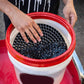 Car wash filter isolation net in red bucket, hands adjusting round perforated disc