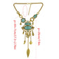 Gold-tone turquoise stone statement necklace with openwork bib and hanging charm drops