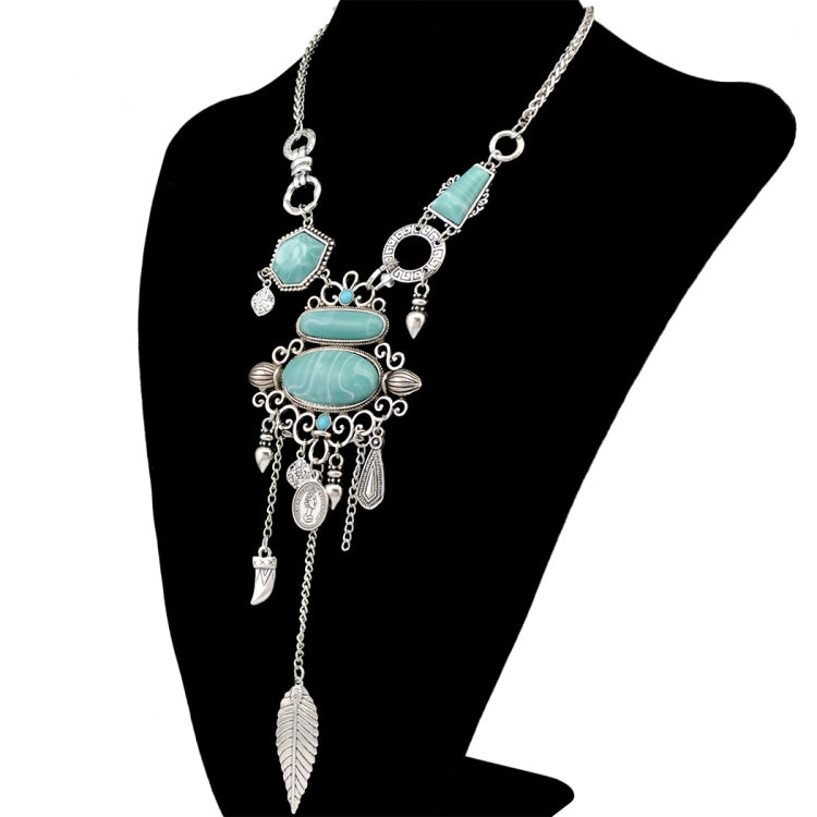 Silver-tone openwork necklace with turquoise oval stones and long dangling leaf charm
