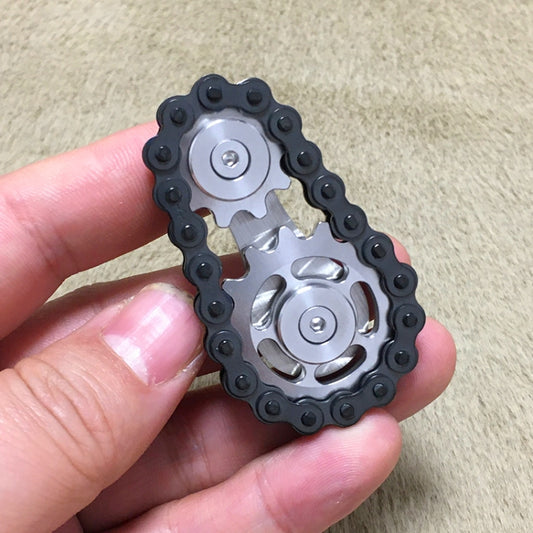 Black chain finger gyro fidget toy with stainless steel gear cores, close-up