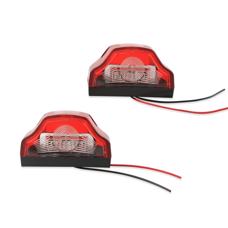 Two red LED license plate lamps with black base, clear lens insert, and red/black wire leads