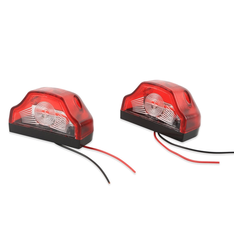 Two red LED license plate lamps with black base and clear lens insert, with wire leads
