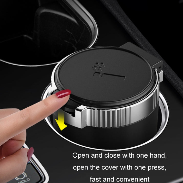 Car ashtray with hinged cover being opened/closed, black top and silver ring