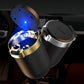 Car ashtray with open cover and blue LED light, black body with silver and gold rim