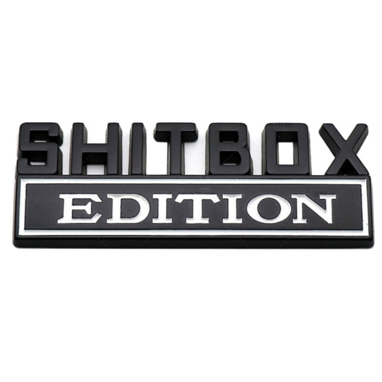 Rear car badge plate with black SHITBOX letters and white EDITION label