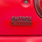 SHITBOX EDITION rear badge mounted on a red car body panel