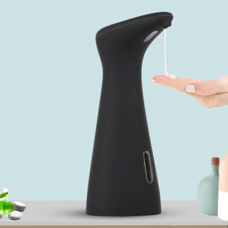 Black automatic soap dispenser with top nozzle and finger-touch sensor area
