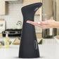 Black automatic soap dispenser with 5 cm height marking and finger pointing at sensor