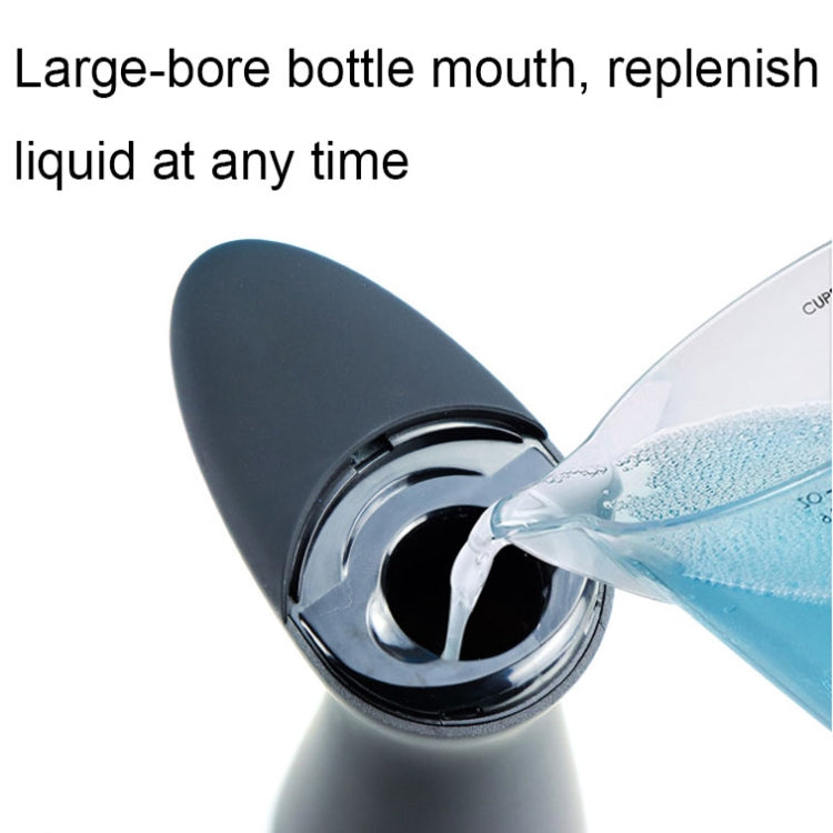 Black automatic soap dispenser with wide bottle mouth showing liquid pouring in