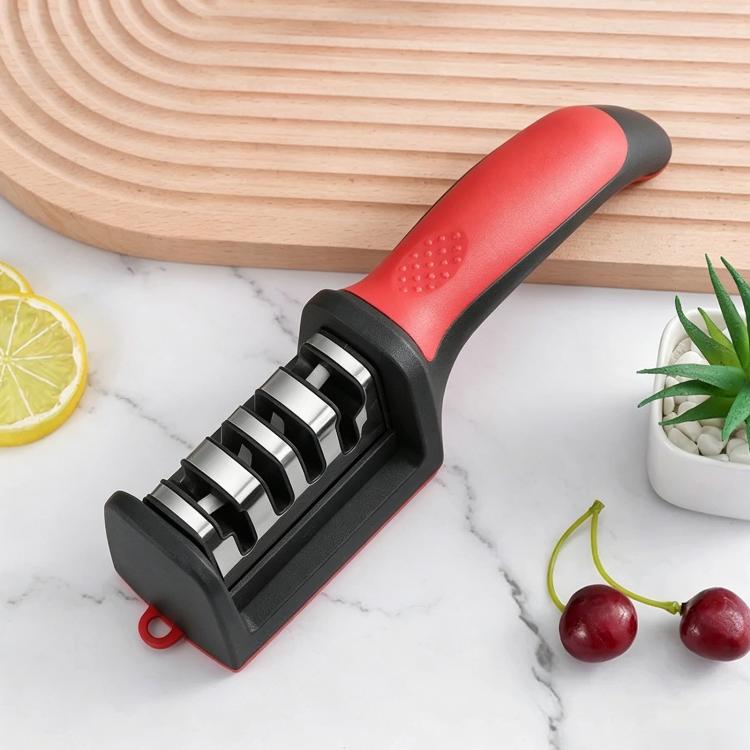 Red and black multi-stage handheld knife sharpener with sharpening slots