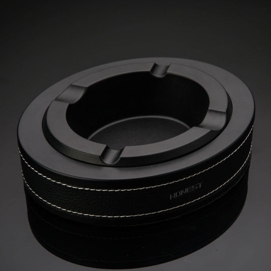 Black metal cigar ashtray with round tray and three cigar rest slots on a leather band