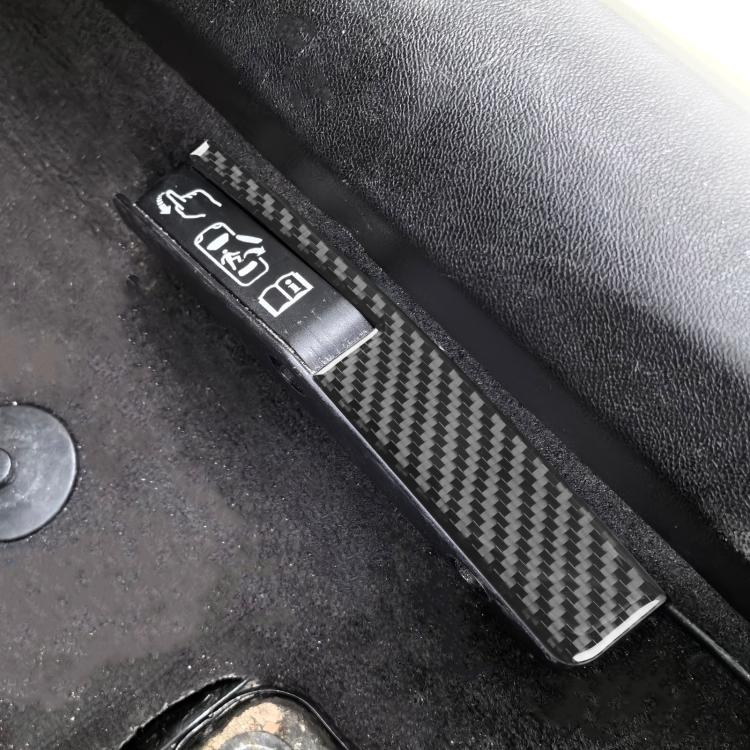 Carbon-fiber-look door lock switch trim strip with matching accents on car door.